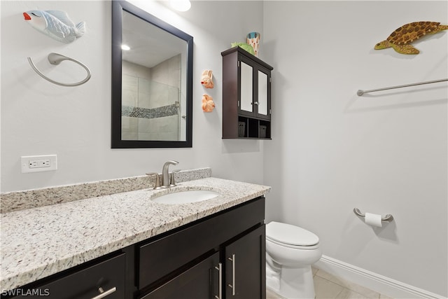 bathroom with tile patterned floors, vanity, toilet, and walk in shower