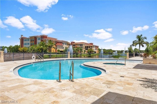 view of swimming pool featuring a patio area and a community hot tub