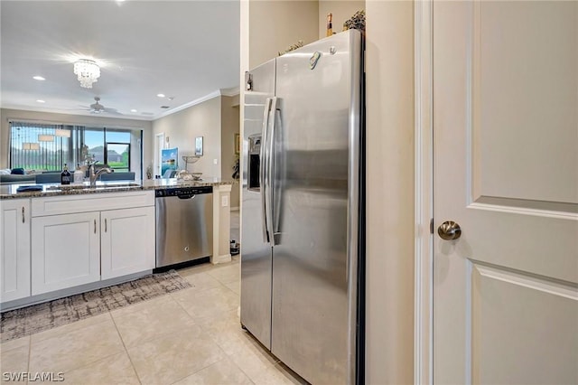 kitchen featuring white cabinets, sink, ceiling fan, ornamental molding, and stainless steel appliances