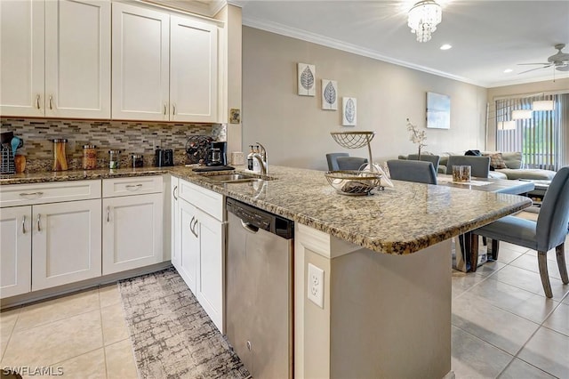 kitchen with kitchen peninsula, stainless steel dishwasher, and crown molding