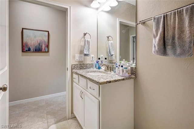 bathroom featuring tile patterned flooring and vanity