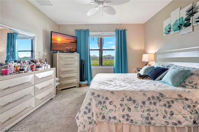 bedroom with light colored carpet and ceiling fan