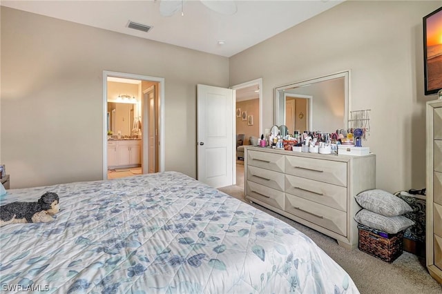 carpeted bedroom featuring ensuite bathroom and ceiling fan