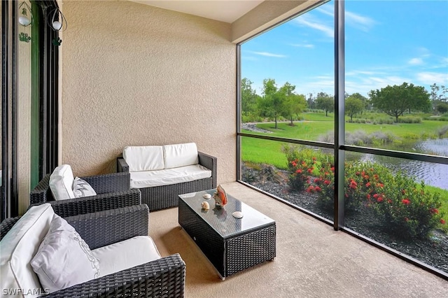 sunroom featuring a water view