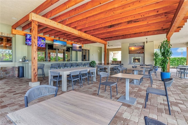 view of patio with a bar and an outdoor fireplace