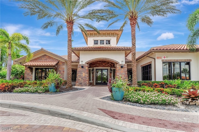 mediterranean / spanish house featuring french doors