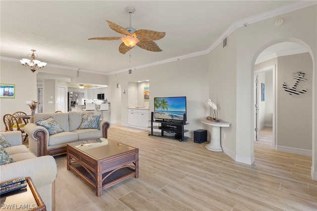 living room featuring ceiling fan with notable chandelier and crown molding