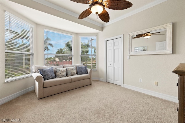 sitting room with a healthy amount of sunlight, carpet floors, and crown molding