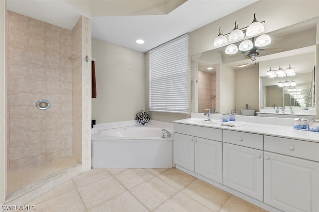 bathroom featuring tile patterned flooring, shower with separate bathtub, and vanity