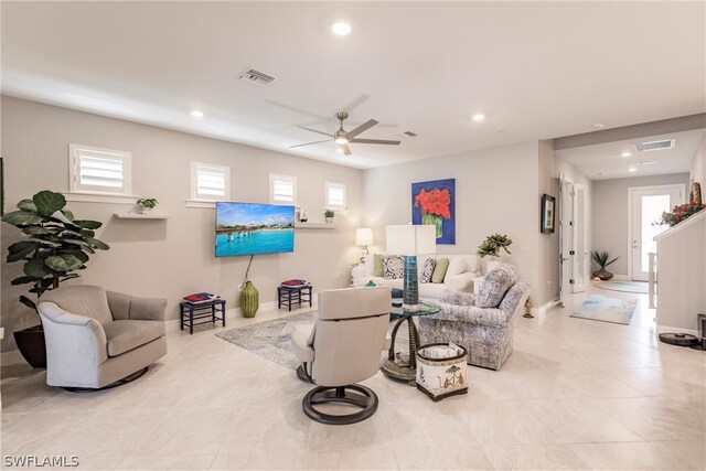 living room with ceiling fan and plenty of natural light