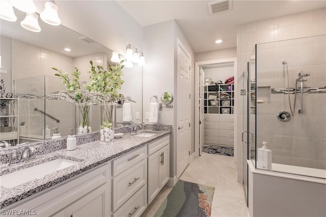 bathroom featuring an enclosed shower, vanity, and tile patterned flooring