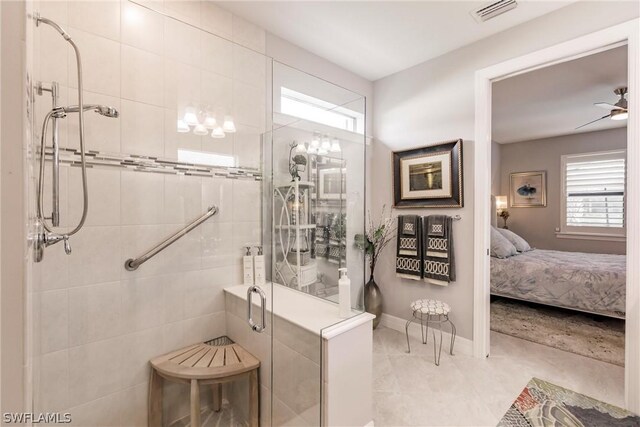 bathroom featuring a shower with shower door and ceiling fan