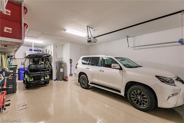 garage featuring electric water heater and a garage door opener