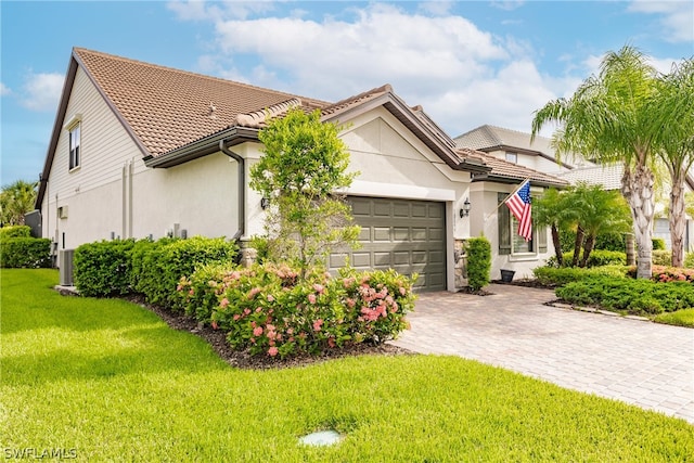 view of front of home with a garage and a front yard