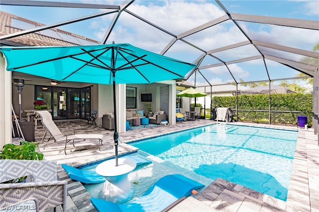 view of pool featuring a lanai, ceiling fan, and a patio area