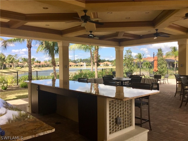 view of patio / terrace featuring ceiling fan and an outdoor bar