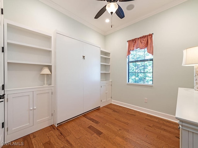 unfurnished bedroom with light hardwood / wood-style flooring, ceiling fan, and ornamental molding