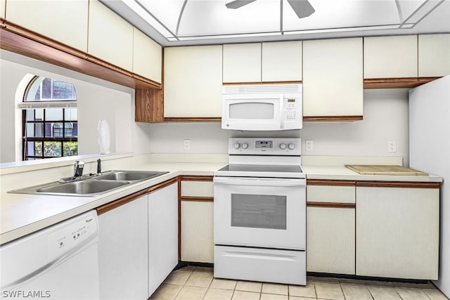 kitchen featuring white appliances, ceiling fan, sink, light tile patterned floors, and white cabinetry