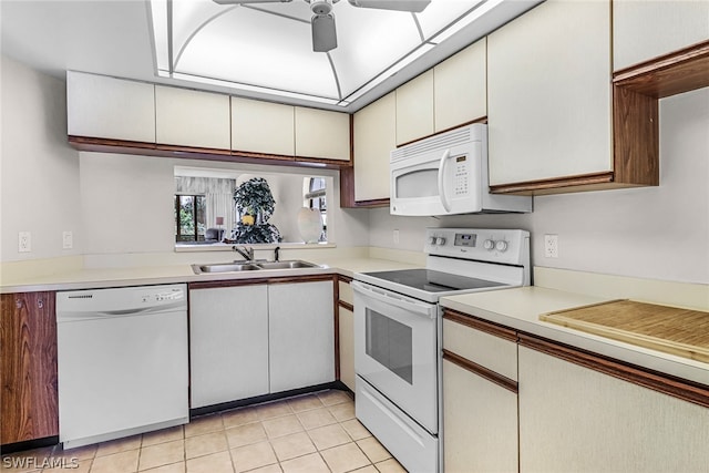 kitchen with white appliances, ceiling fan, sink, light tile patterned floors, and white cabinetry