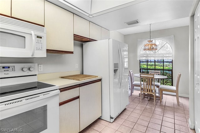 kitchen featuring white cabinetry, an inviting chandelier, decorative light fixtures, white appliances, and light tile patterned floors