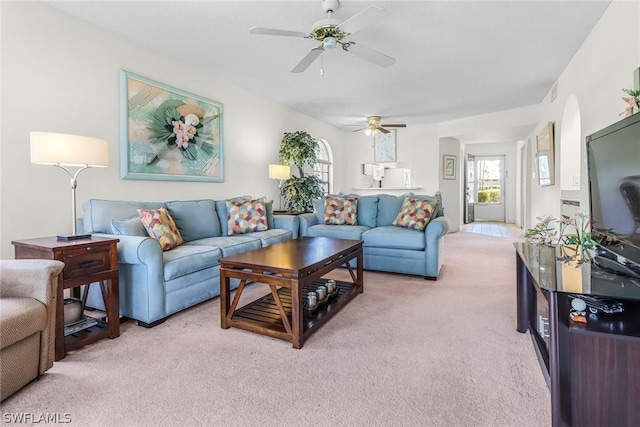 living room with light carpet and ceiling fan