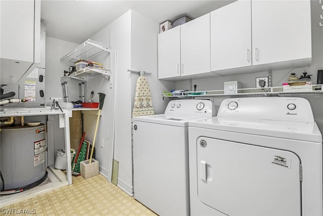 clothes washing area with cabinets, separate washer and dryer, and water heater