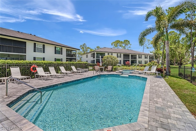 view of pool featuring a hot tub and a patio area