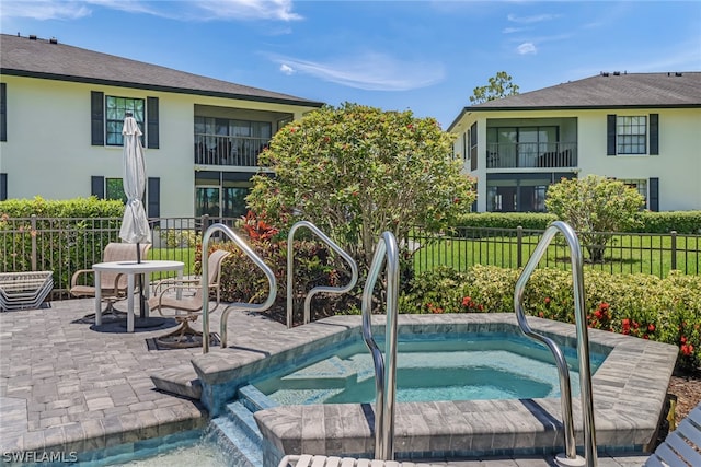 view of swimming pool with a patio area and an in ground hot tub