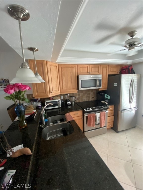 kitchen with ceiling fan, tasteful backsplash, stainless steel appliances, pendant lighting, and sink