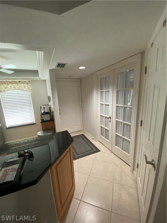 kitchen with ceiling fan, french doors, and light tile flooring