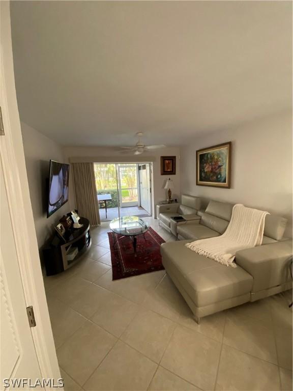 tiled living room with ceiling fan