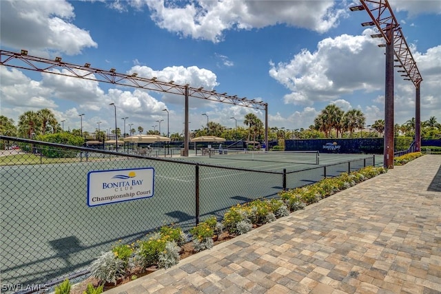 view of sport court featuring fence