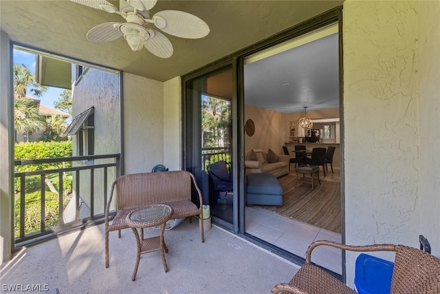 sunroom with a healthy amount of sunlight and ceiling fan