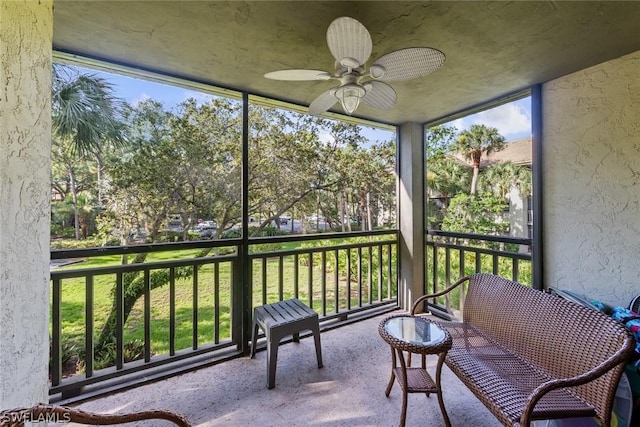 unfurnished sunroom featuring ceiling fan and a wealth of natural light