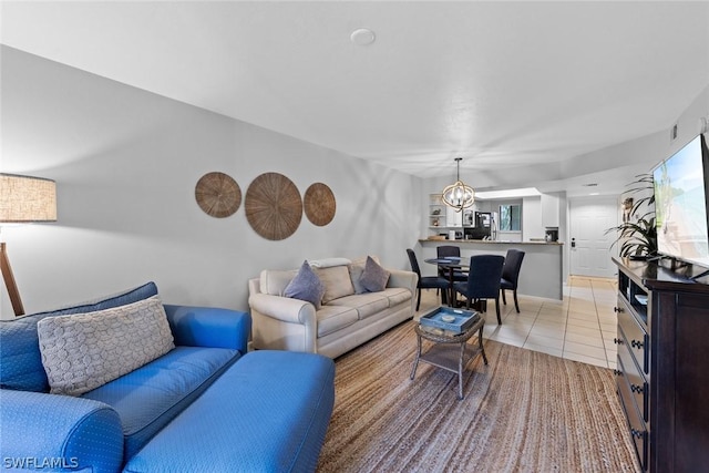 living room with an inviting chandelier and light tile patterned floors