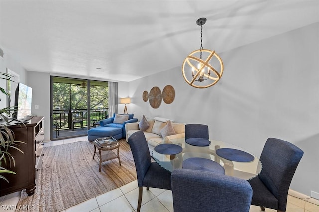 dining space featuring light tile patterned floors, a wall of windows, and an inviting chandelier