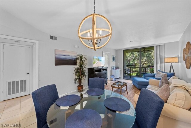 dining room featuring a notable chandelier and light tile flooring