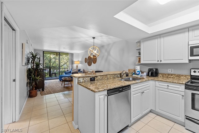 kitchen featuring kitchen peninsula, white cabinetry, appliances with stainless steel finishes, sink, and light tile floors