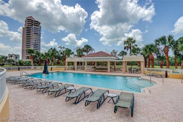 community pool featuring a gazebo, a patio area, and fence