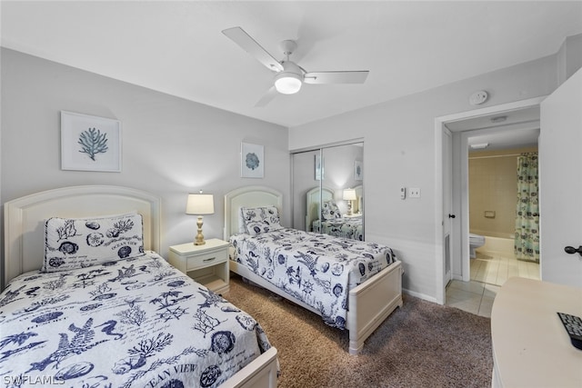 tiled bedroom featuring ceiling fan, a closet, and ensuite bathroom