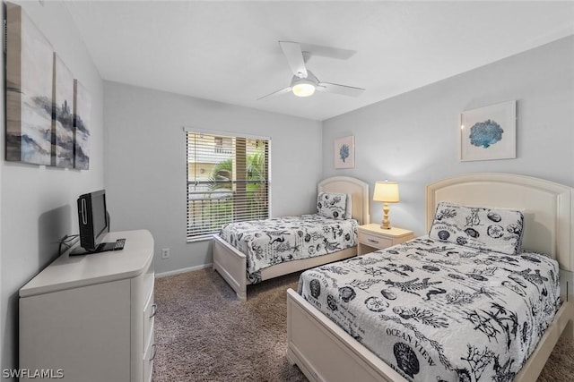 bedroom featuring dark colored carpet, ceiling fan, and baseboards