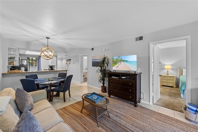 carpeted living room featuring a chandelier