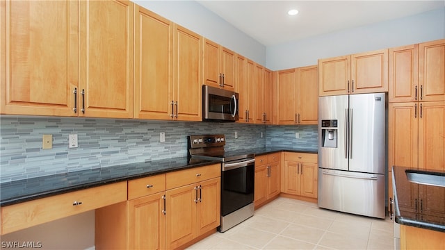 kitchen with decorative backsplash, light tile patterned flooring, dark stone countertops, and stainless steel appliances