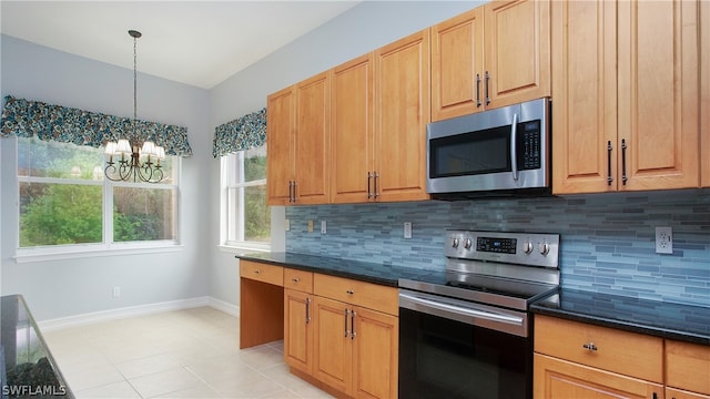 kitchen featuring appliances with stainless steel finishes, tasteful backsplash, dark stone counters, decorative light fixtures, and a chandelier