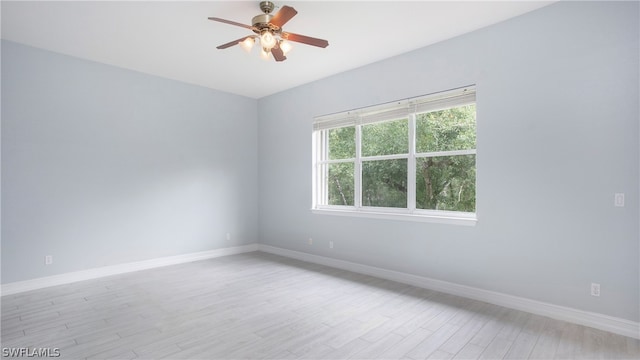 empty room featuring ceiling fan and light hardwood / wood-style floors