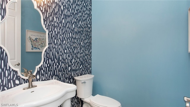 bathroom with toilet and sink