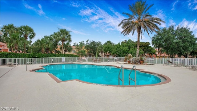 community pool featuring a patio area and fence