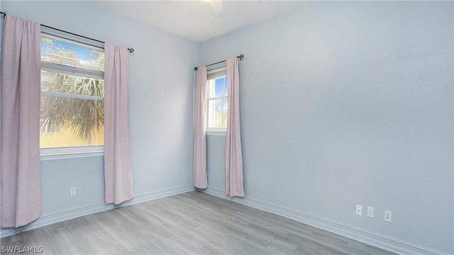 unfurnished room with wood finished floors and baseboards