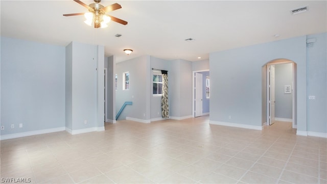 unfurnished room with light tile patterned floors and ceiling fan