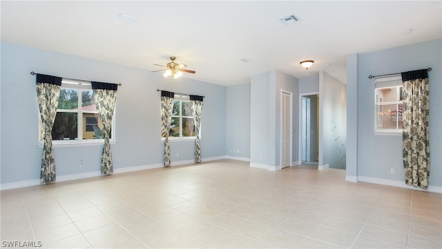 unfurnished room with ceiling fan and light tile patterned floors